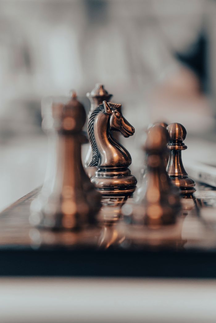 our-services-05 Artistic close-up of chess pieces, highlighting a knight in focus. Perfect for strategic planning themes.
