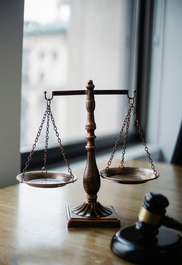 Incorporating Your Business in BC: What You Need to Know Before You File Decorative judgement scale and gavel placed on desk in light lawyer office against window