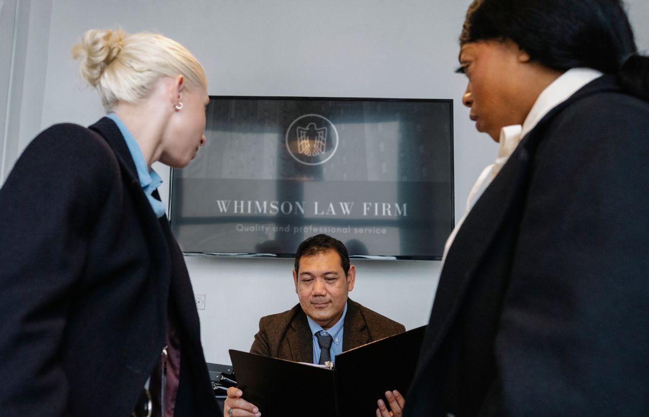 hero-gallery-01 Diverse colleagues gathering in conference hall of law firm and discussing details of contract while working together